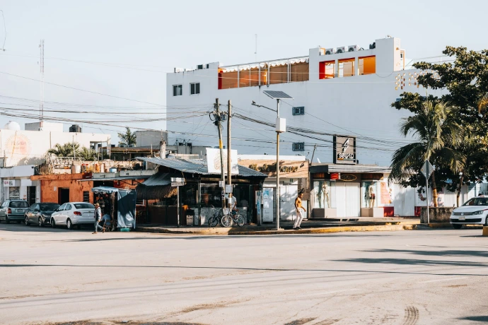 a street corner with a few cars parked on the side of the road